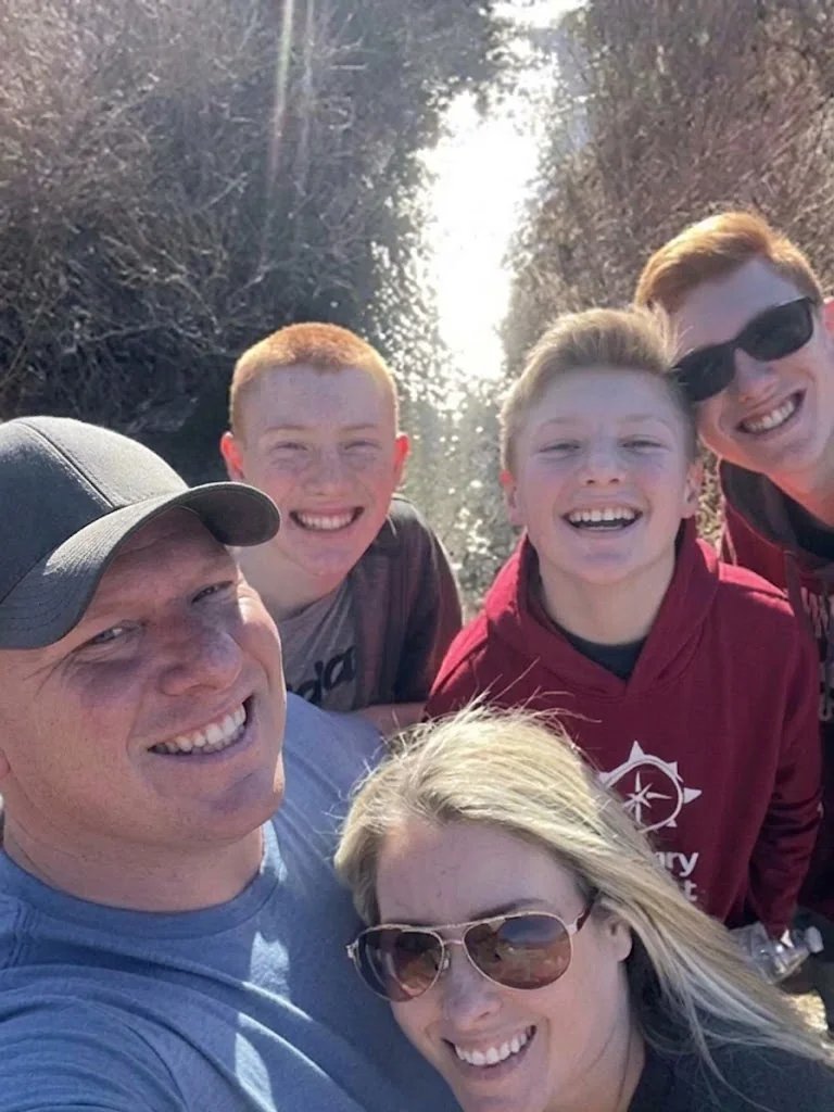 Family smiling outdoors together