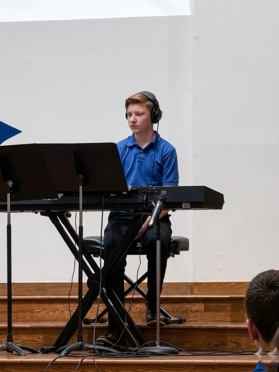 Simon playing piano on stage